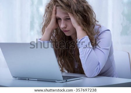 Image of despair girl humilated on internet by classmate