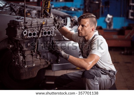 Car mechanic and car engine outside the vehicle