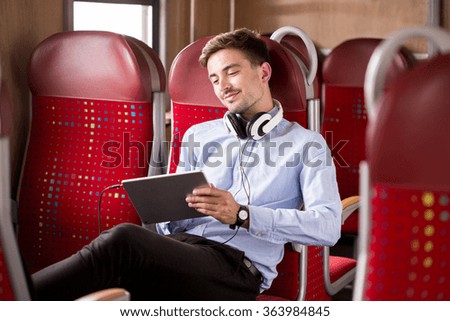 Photo of modern commuter relaxing on train after work