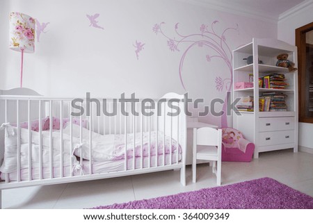 Close-up of white crib in cozy nursery