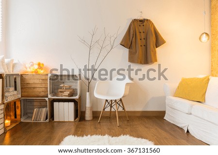 Up-to-date designed lounge with wooden floor and white soft sheepskin on it