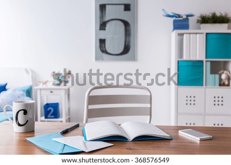 Study room for child with wood desk and simple white chair