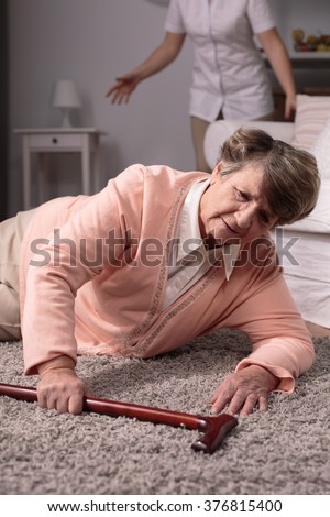 Senior disabled woman with walking stick fall on floor