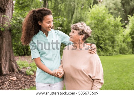 Nurse is walking around with elder lady