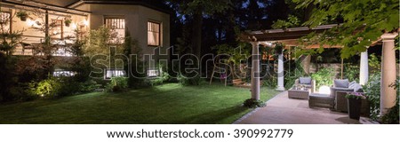 Luxury villa with patio in garden at night