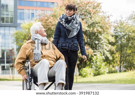Picture of caring young woman helping her disabled relative