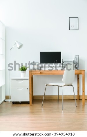 Study room with wood flooring and simple, light furniture