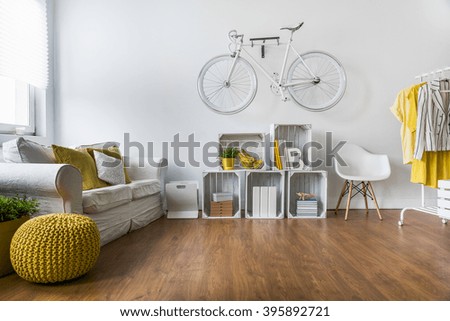 Wooden parquet in big living room with comfortable white sofa and vintage decorations