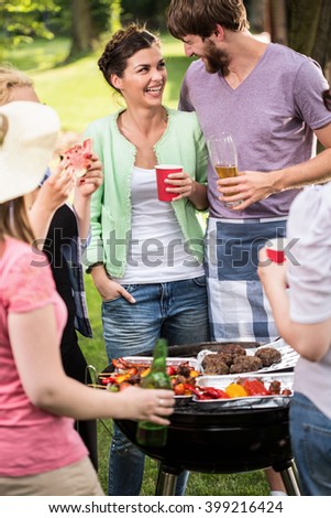 Young couple laughing at the barbecue party