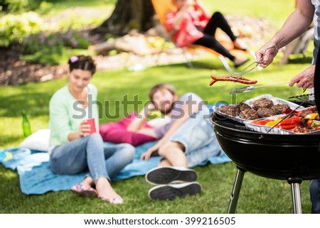 Barbecue in park with friends on a sunny afternoon