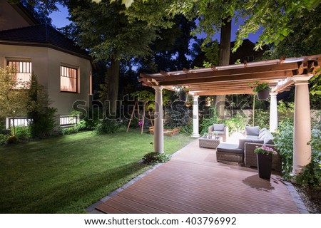 Photo of garden with covered patio at night