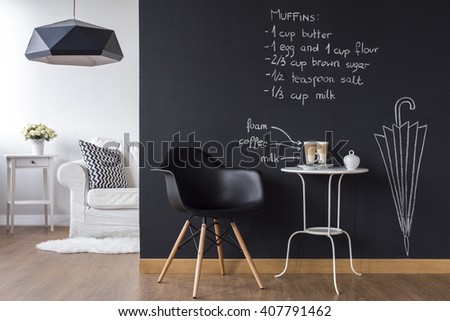 Shot of a modern living room with a chalkboard wall