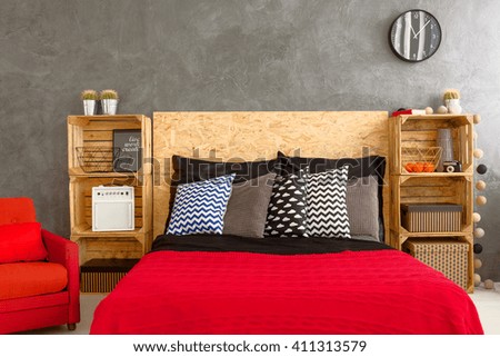 New bedroom with handmade, wood regales, big bed and red bedding