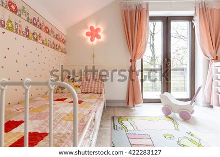 Shot of a spacious pink bedroom for a little girl