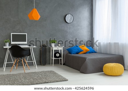 Stylish designed boy teenager\'s bedroom with grey walls and white furniture and colorful decorations