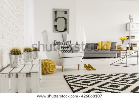 Spacious interior wirh decorative brick wall and new, stylish furniture
