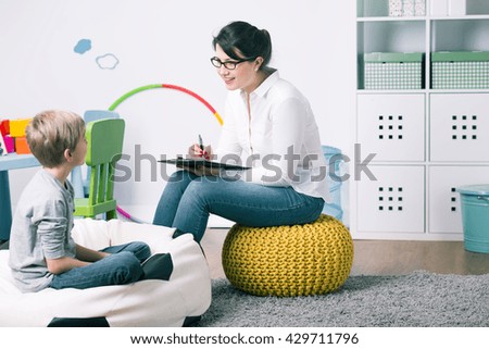 Shot of a young child psychologist talking with a boy