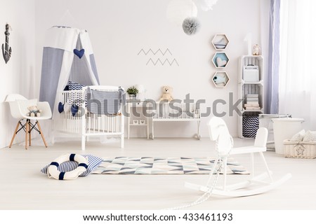 Light and spacious baby room in marine style with stylish navy decorations