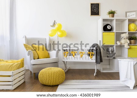 Shot of a modern cozy baby room with yellow accessories