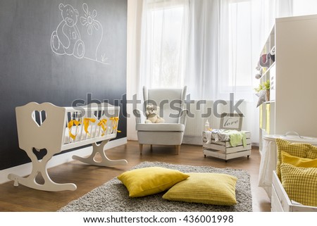 Shot of a spacious modern nursery room with a chalkboard wall