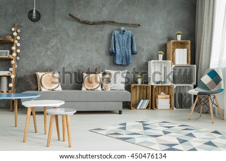 Grey living room in new style with DIY furniture, chair, pattern carpet, sofa and creative home decorations