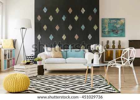 Modern flat with blackboard, pattern carpet, new crystal chair, yellow pouffe and sofa