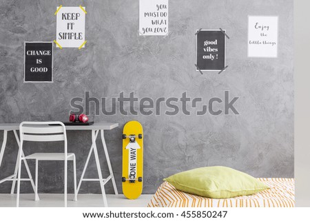 Cropped shot of a teenager room interior with a minimalistic desk and a single bed