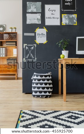Cropped shot of a large blackboard wall with posters in a modern living room
