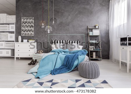New style spacious bedroom with white furniture, floor panels and decorative wall plaster