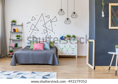 Shot of a bedroom interior with a handmade decorations on the wall