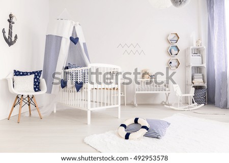 White crib with canopy in marine style interior