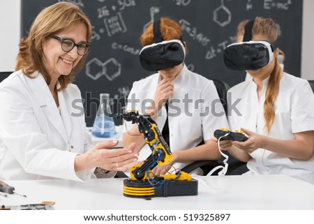 Shot of a professor and two science students wearing VR goggles