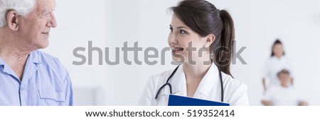 Friendly talk between older male patient and his female doctor