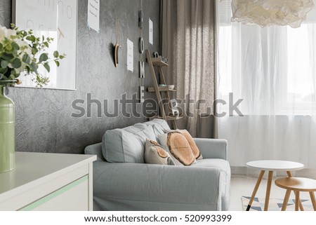 Living room with sofa, small round table and window curtains
