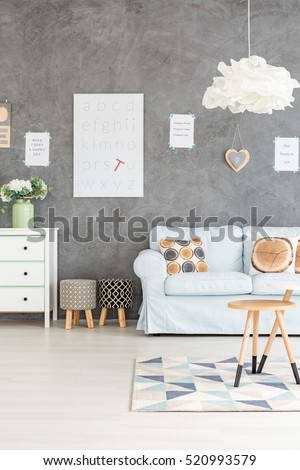 Grey living rooom with sofa, dresser and upholstered stools