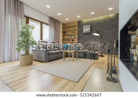 Beige living room with a large corner sofa and a designer floor lamp