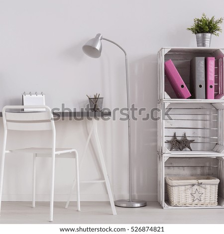 White minimalist home office with simple desk, standing lamp, white chair and DIY bookcase