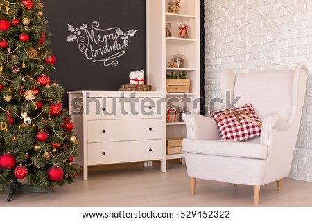 Comfortable white armchair in a living room with christmas decorations