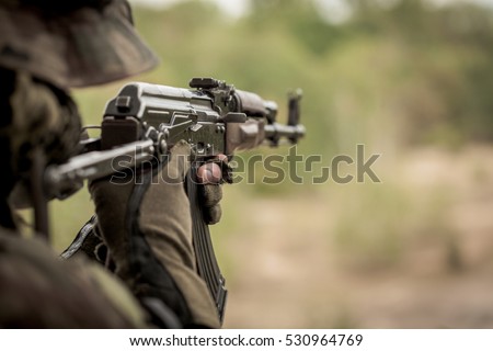 Marine sniper aiming from machine gun during intense training