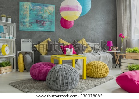 Trendy comfortable wool hassock in colorful room interior