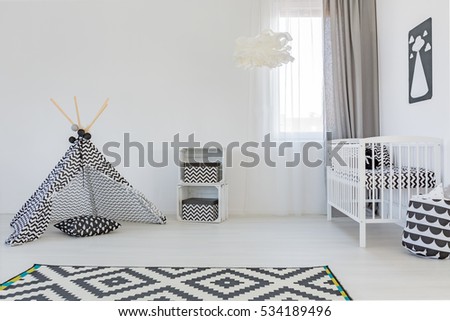 Light baby room with white cot, carpet and play tent