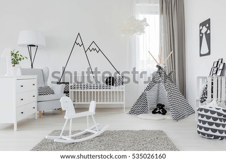 Child room with white furniture, carpet, tent and wall sticker