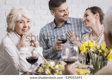 Beautiful young couple celebrating their anniversary with elderly parents