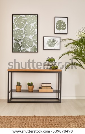 Monstera leaf wall decor, furniture made from wood and metal