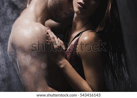 Half-naked man and woman in intimate situation are  touching each other in the shower