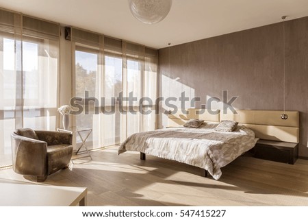 Spacious bedroom interior with marital bed