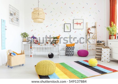 Baby room with white wall and light wooden furniture