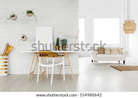 Bright loft apartment with working area and sofa