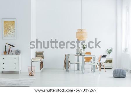 White loft with dining table, chairs and dresser