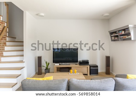 Open living room with tv, sofa and staircase